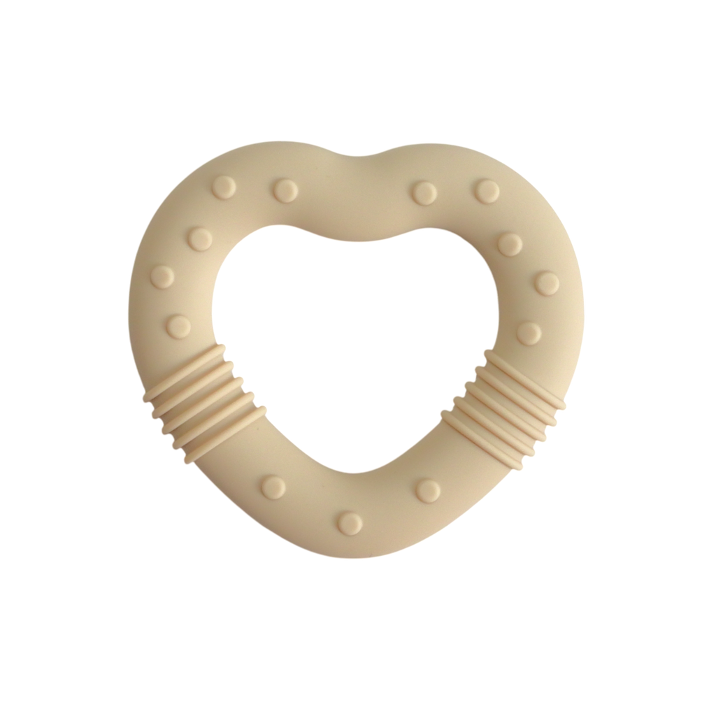 Beige heart-shaped teething ring on a white background